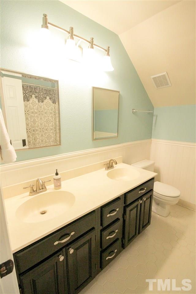 8212 Hambledon Court Raleigh, NC 27615 - Photo 19 of 28 a bathroom with a sink and a mirror