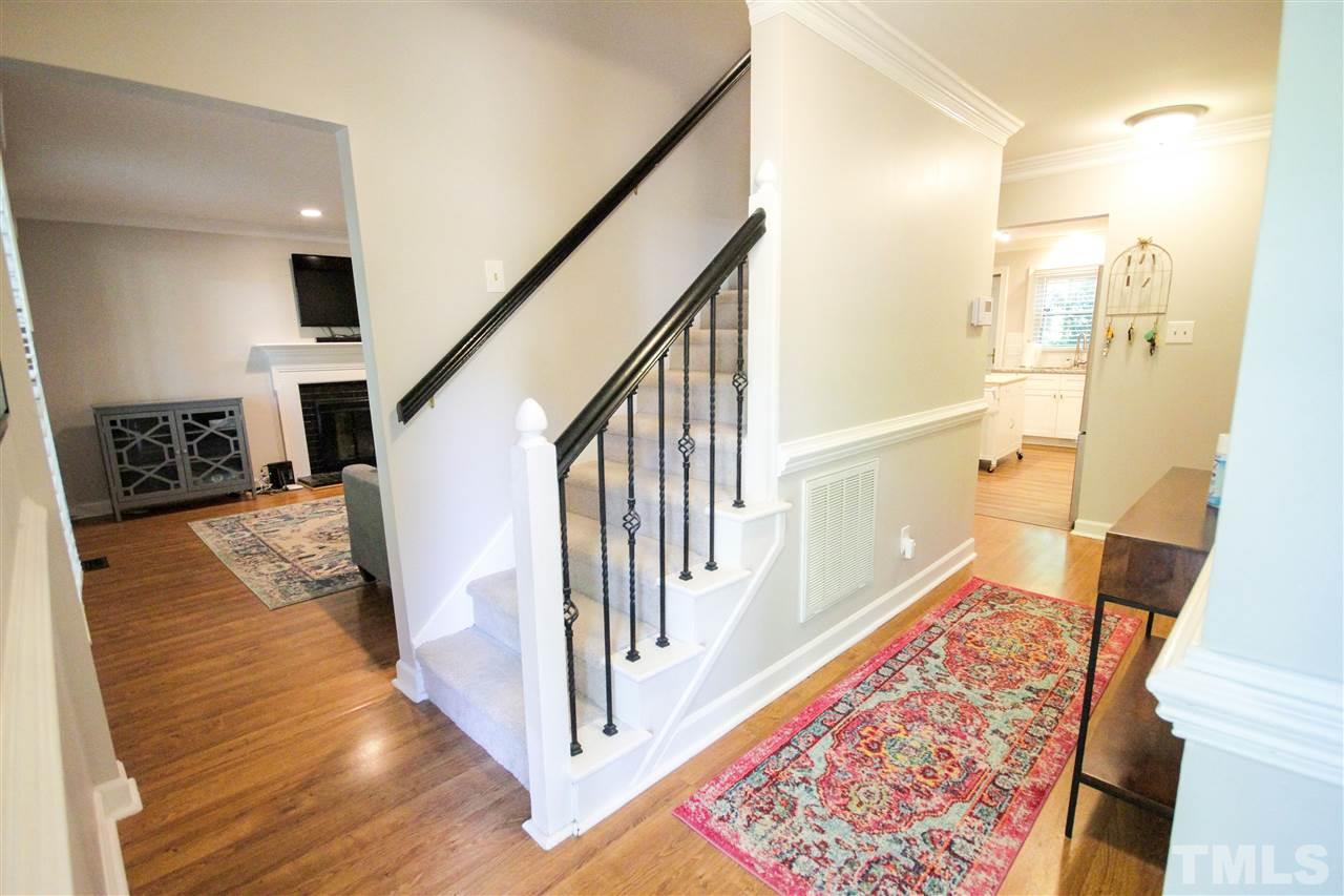 8212 Hambledon Court Raleigh, NC 27615 - Photo 21 of 28 a view of a hallway with wooden floor and staircase