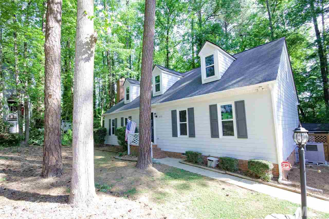 8212 Hambledon Court Raleigh, NC 27615 - Photo 22 of 28 a view of a brick house with a large windows and large tree