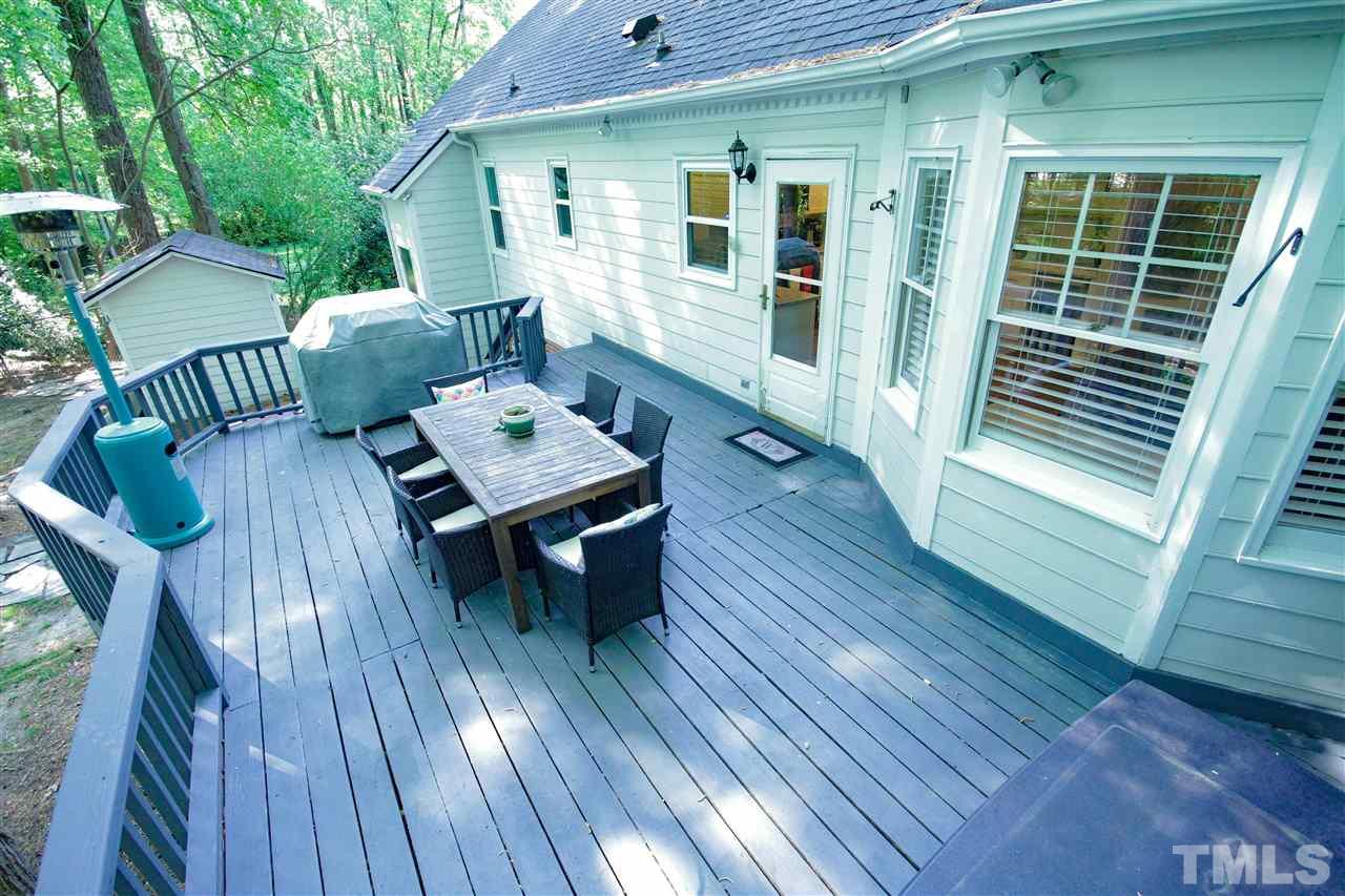 8212 Hambledon Court Raleigh, NC 27615 - Photo 26 of 28 a balcony with wooden floor table and chairs