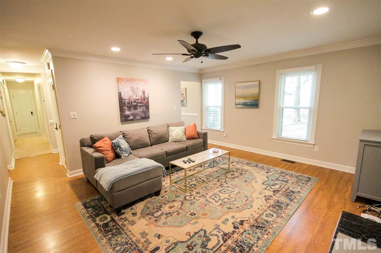 8212 Hambledon Court Raleigh, NC 27615 - Photo 8 of 28 a living room with a couch and a rug