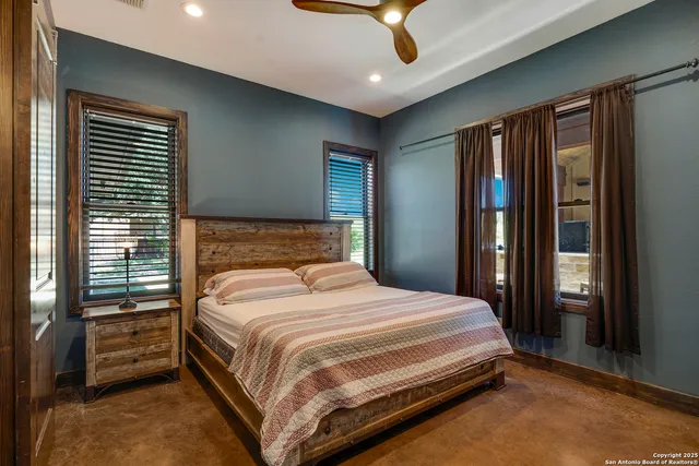 a bedroom with a large bed and a chandelier