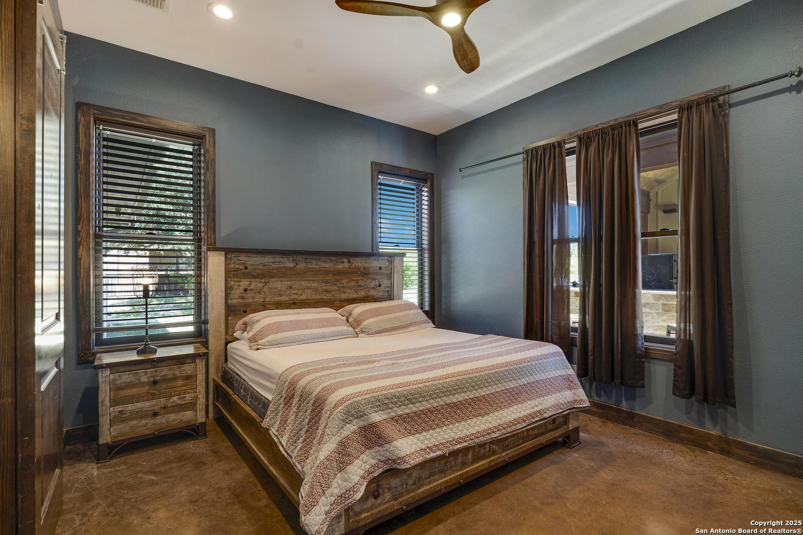 1185 Mountain Vly Drive Concan, TX 78838 - Photo 13 of 27 a bedroom with a large bed and a chandelier