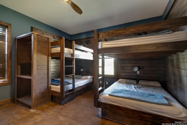 a bedroom with furniture and a ceiling fan