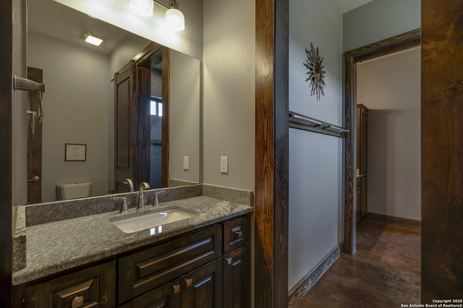 1185 Mountain Vly Drive Concan, TX 78838 - Photo 16 of 27 a bathroom with a granite countertop sink and a mirror