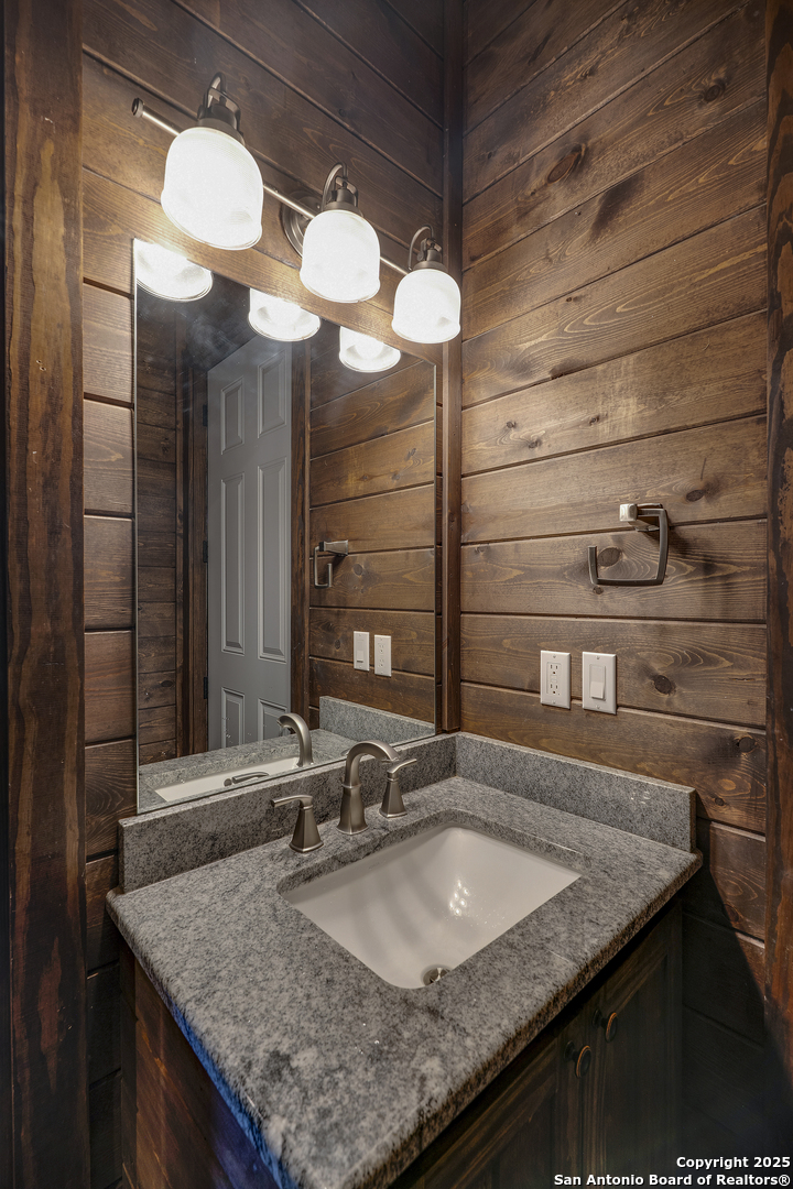 1185 Mountain Vly Drive Concan, TX 78838 - Photo 20 of 27 a kitchen with a granite countertop sink and a mirror