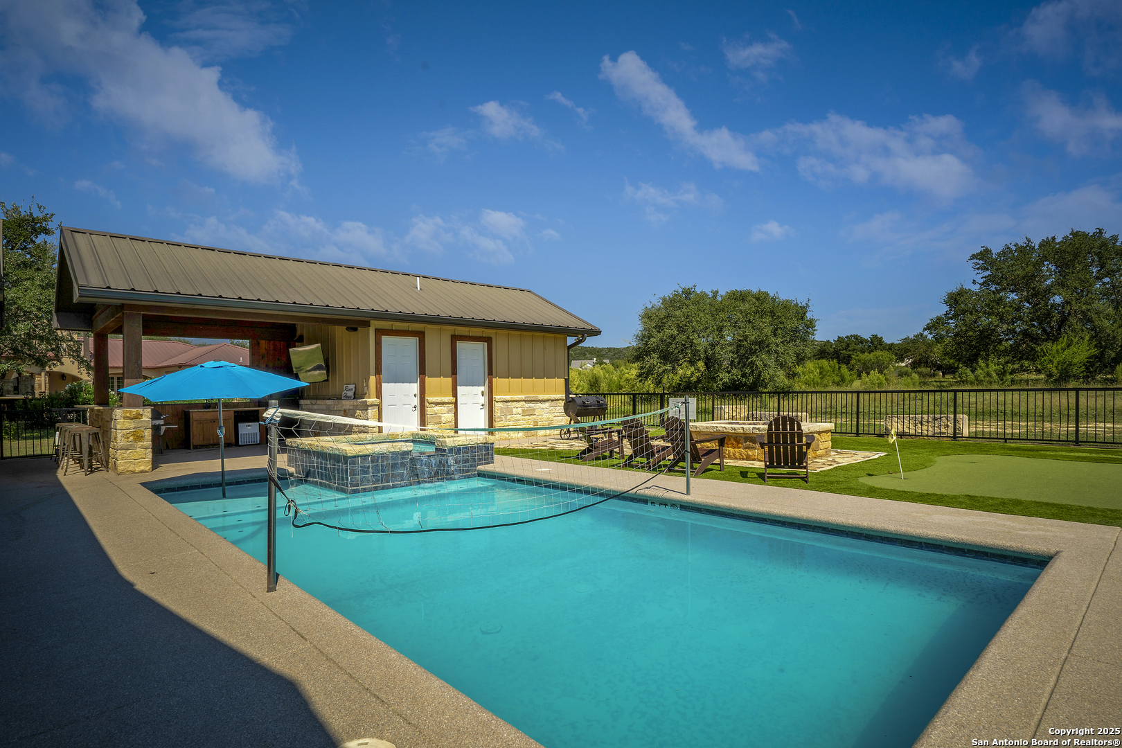 1185 Mountain Vly Drive Concan, TX 78838 - Photo 22 of 27 a view of a house with swimming pool and sitting area