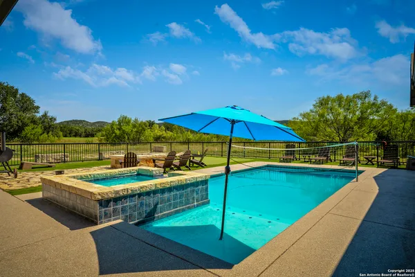 a view of a house with swimming pool and yard