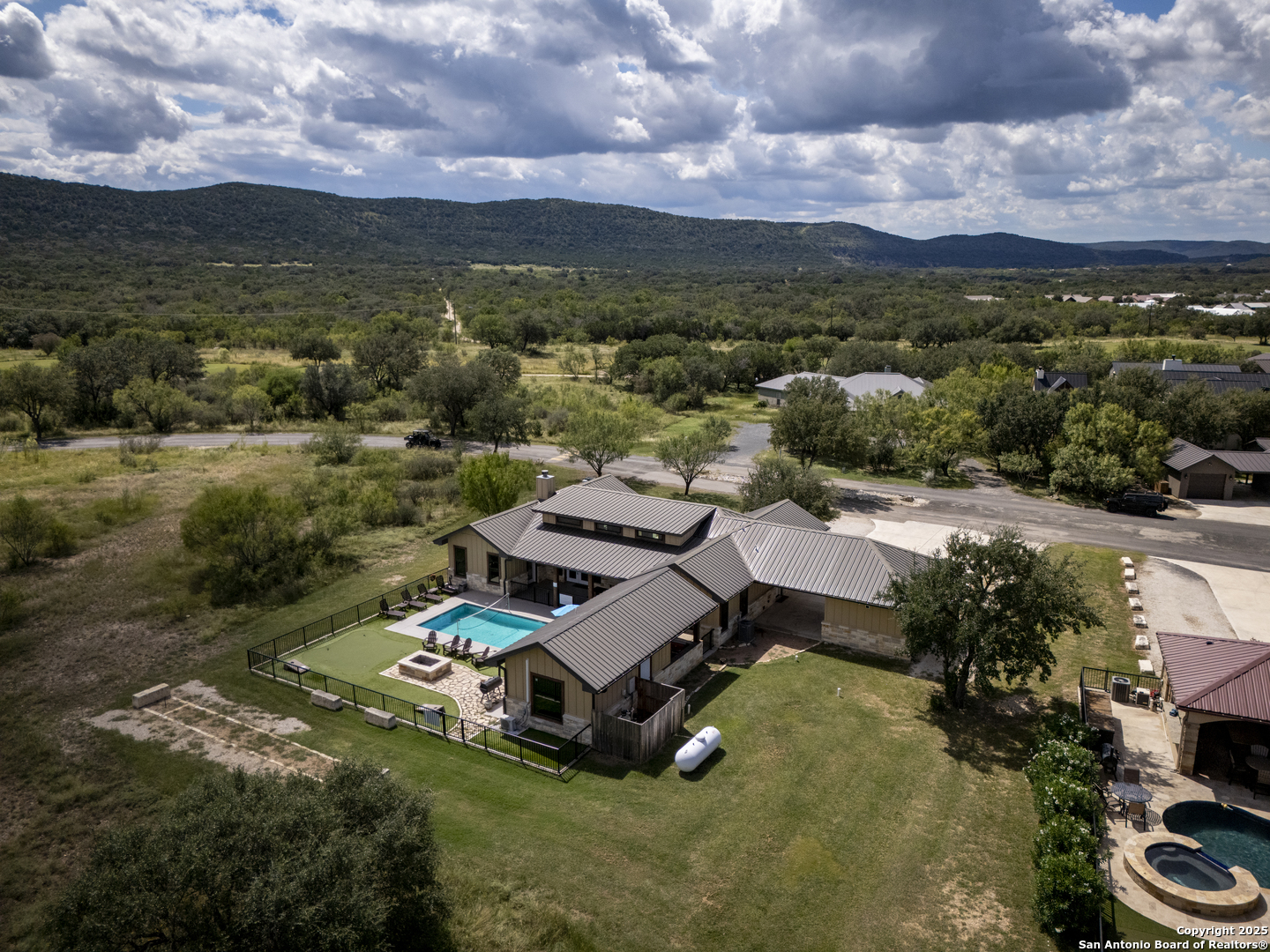 1185 Mountain Vly Drive Concan, TX 78838 - Photo 7 of 27 an aerial view of a house with a garden