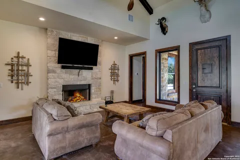 a living room with furniture fireplace and flat screen tv