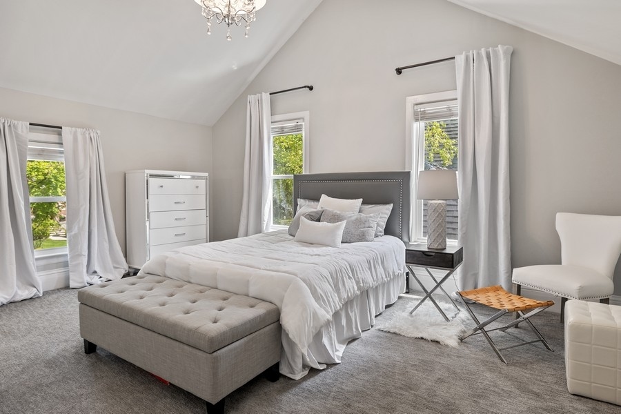 618 Willow Road Winnetka, IL 60093 - Photo 22 of 27 a bedroom with a bed a table and chair