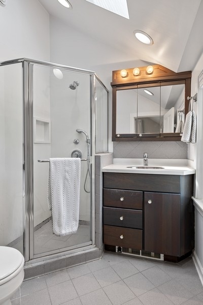 618 Willow Road Winnetka, IL 60093 - Photo 23 of 27 a bathroom with a double vanity sink mirror and toilet