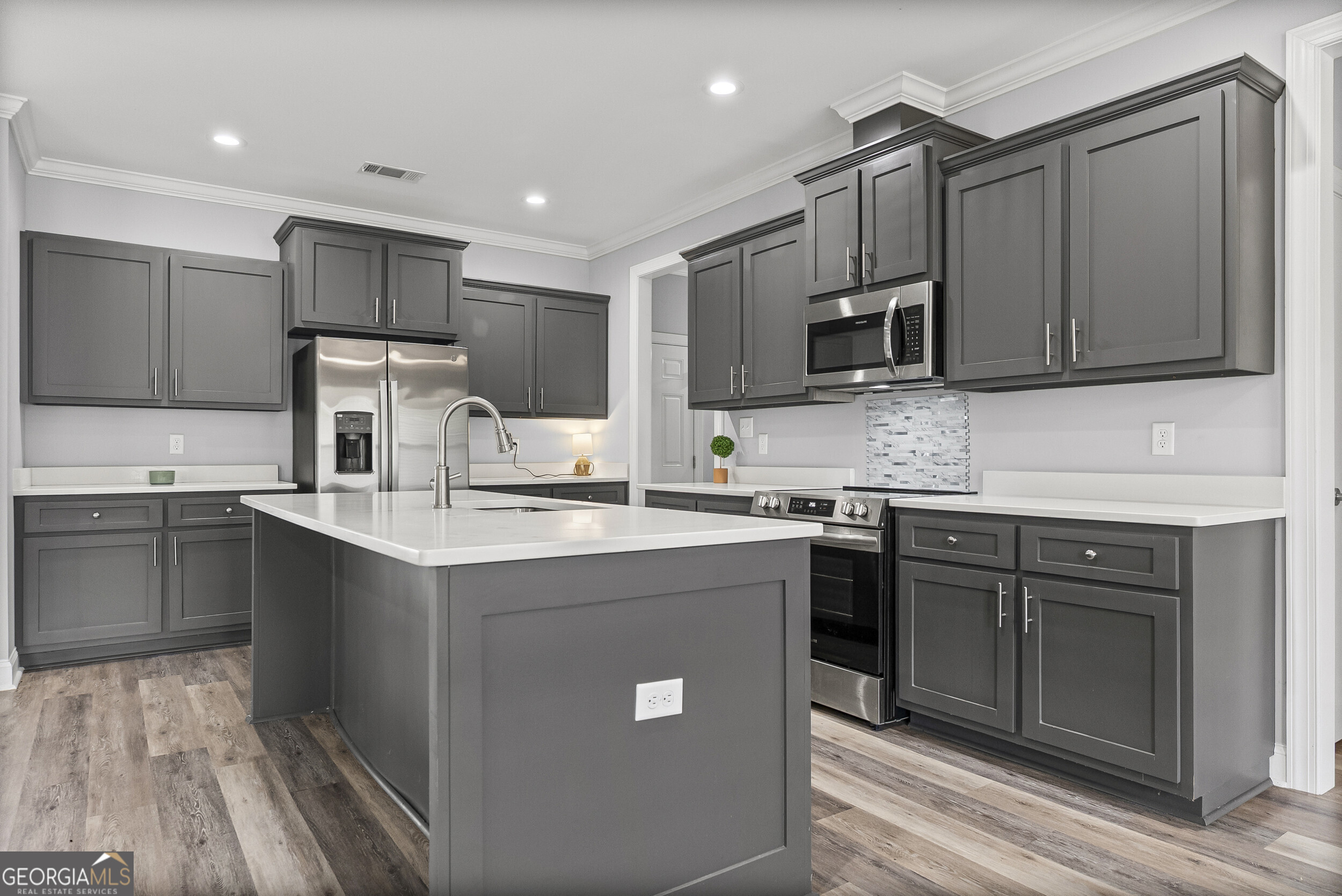 144 Scarlet Way Leesburg, GA 31763 - Photo 12 of 30 a kitchen with kitchen island granite countertop stainless steel appliances and sink