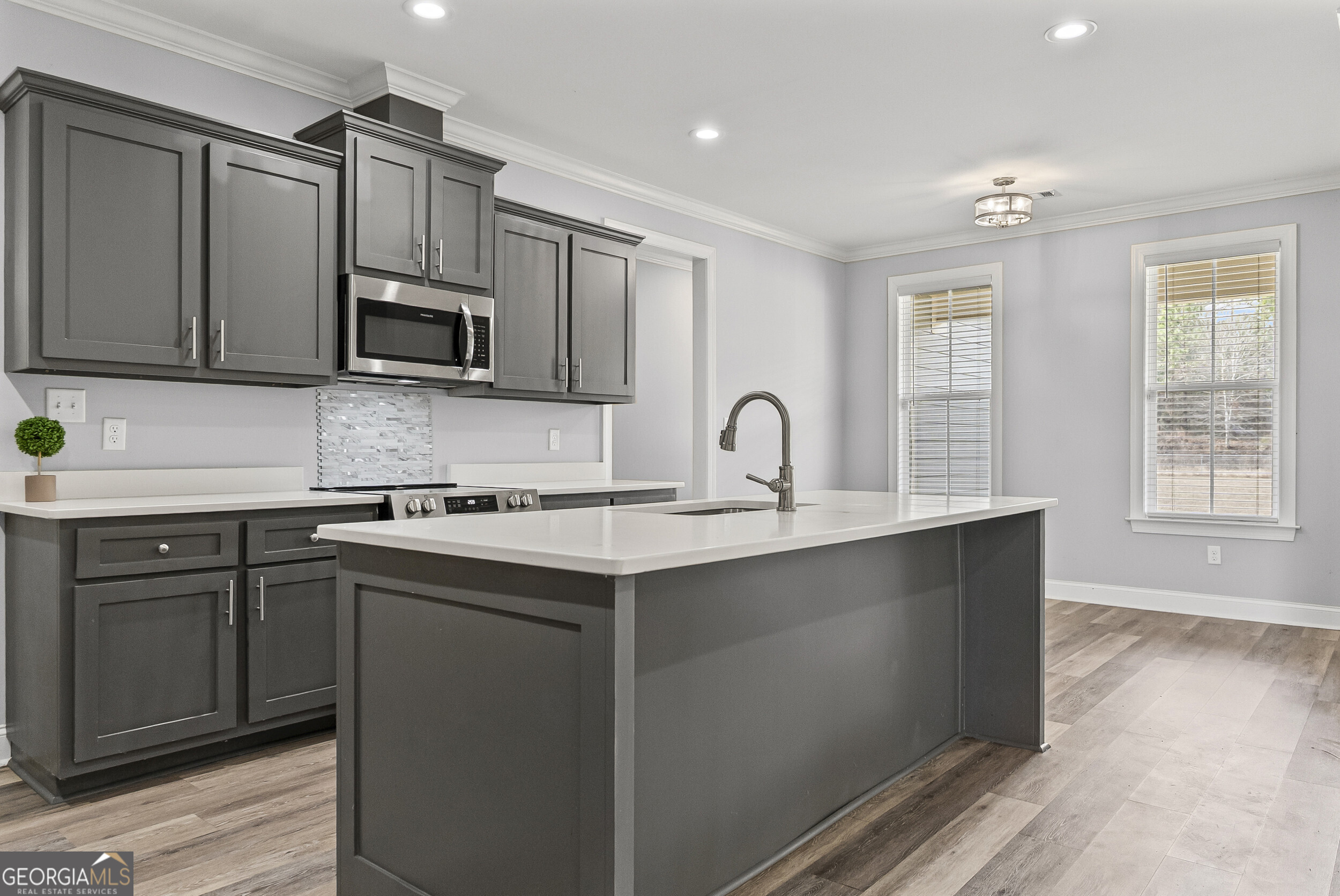144 Scarlet Way Leesburg, GA 31763 - Photo 13 of 30 a kitchen with stainless steel appliances a sink stove and microwave