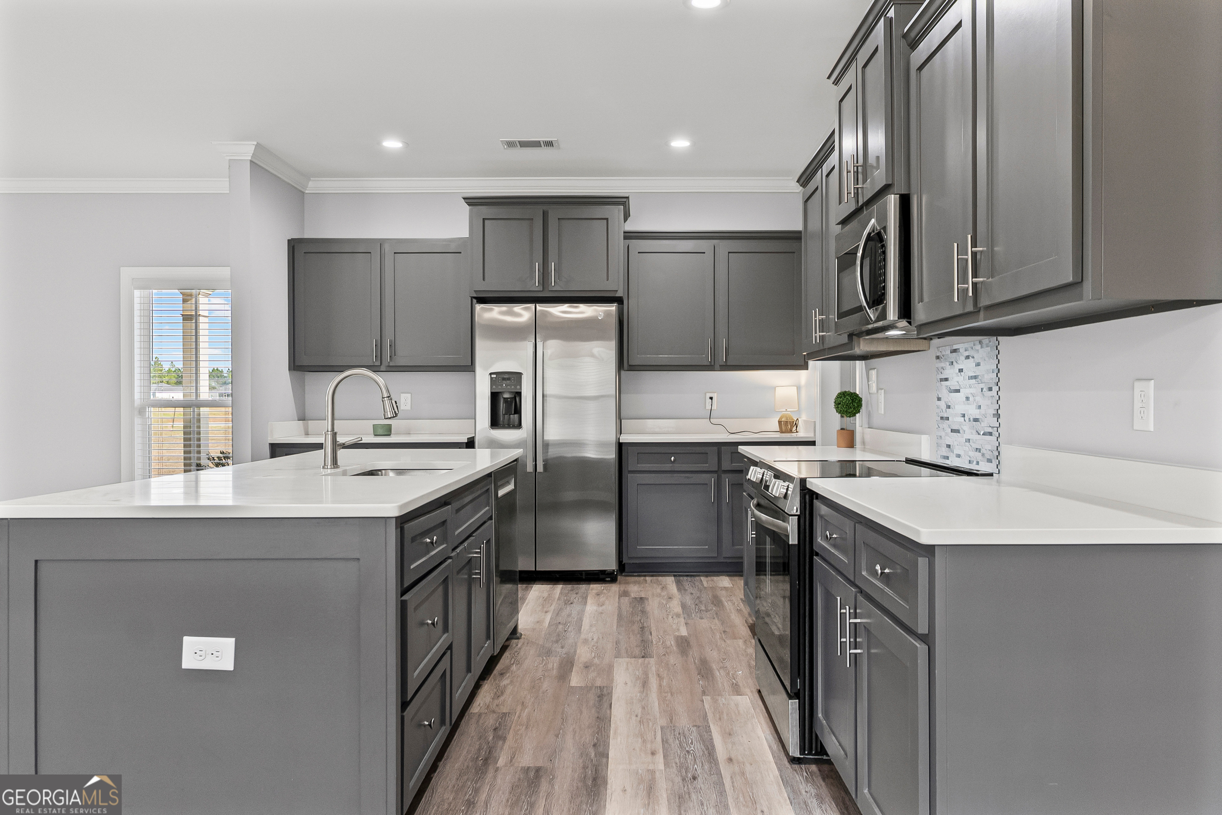 144 Scarlet Way Leesburg, GA 31763 - Photo 14 of 30 a kitchen with stainless steel appliances granite countertop a sink stove and refrigerator
