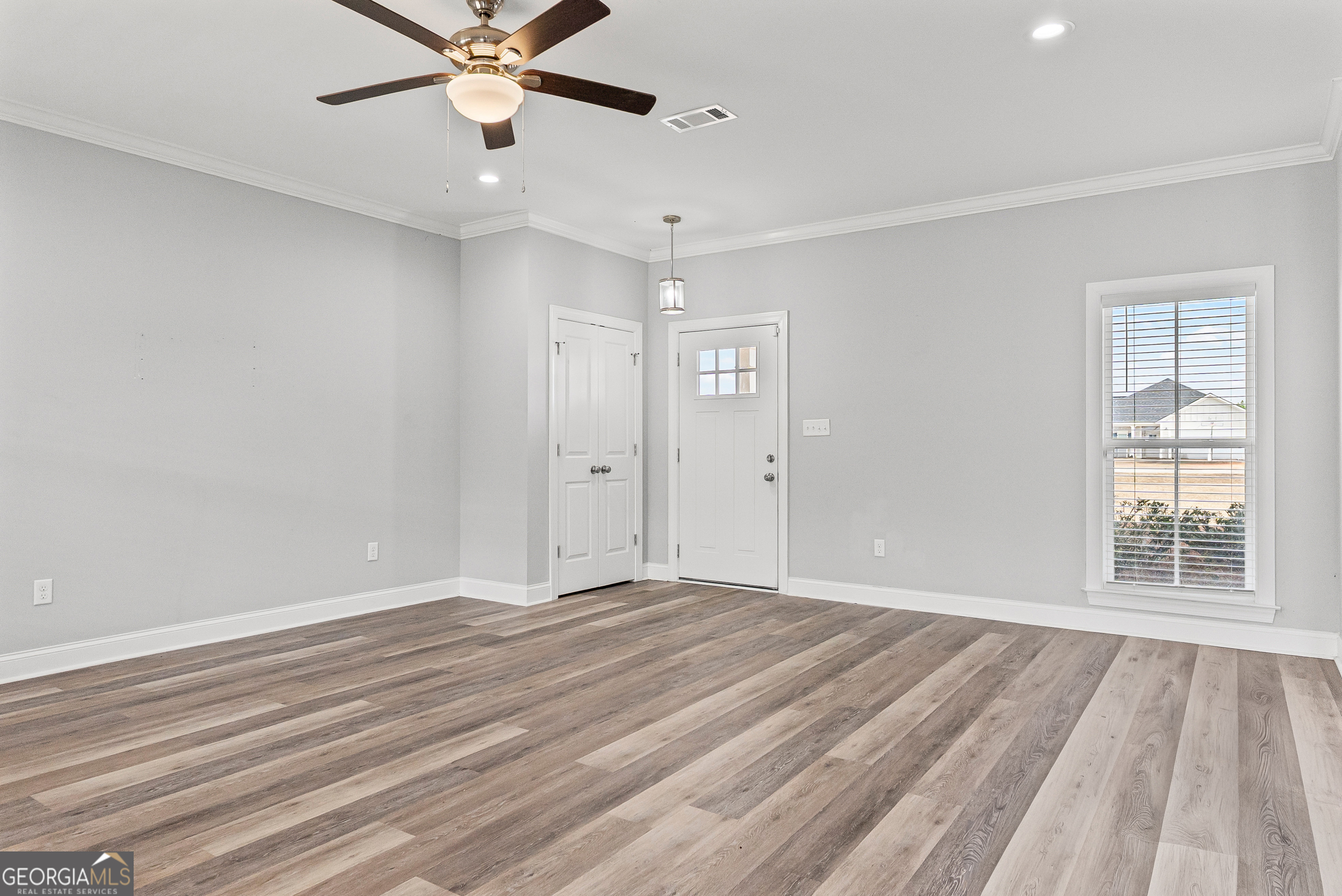 144 Scarlet Way Leesburg, GA 31763 - Photo 8 of 30 a view of an empty room with wooden floor and a window