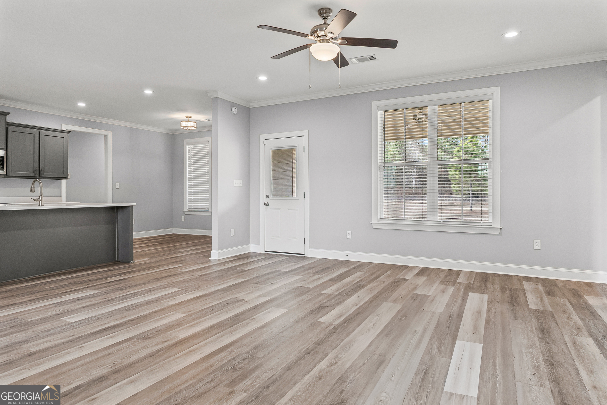 144 Scarlet Way Leesburg, GA 31763 - Photo 9 of 30 a view of empty room with wooden floor and fan