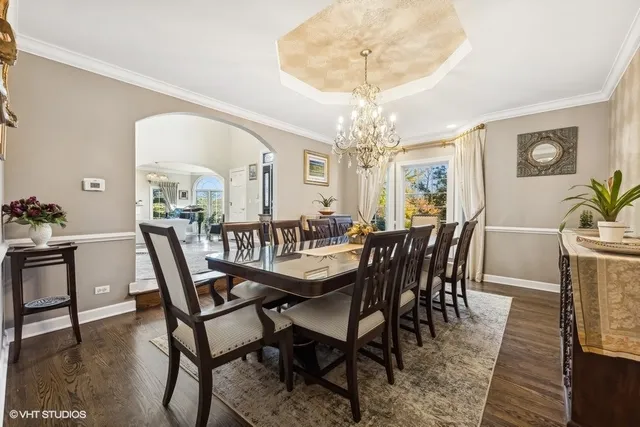a view of a dining room with furniture and chandelier