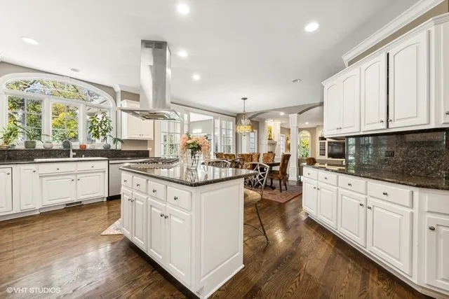 a kitchen with stainless steel appliances granite countertop a stove sink and cabinets