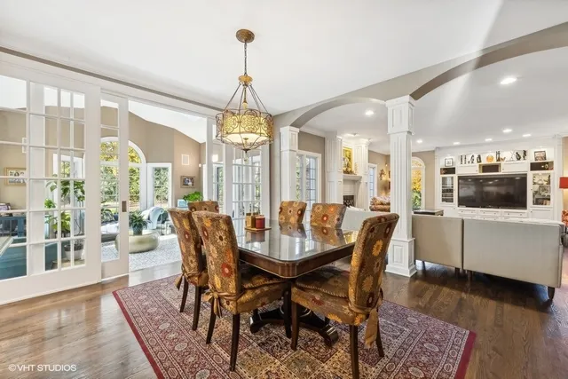 a living room with fireplace furniture and a large window