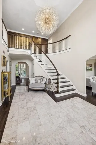 a bedroom with a large bed and a chandelier