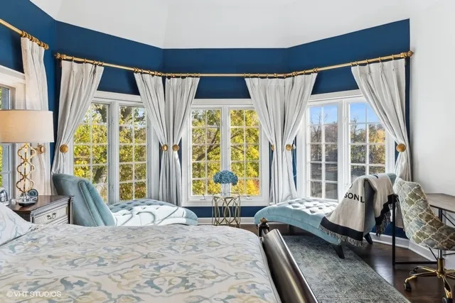 a bedroom with a bed a couch and a window