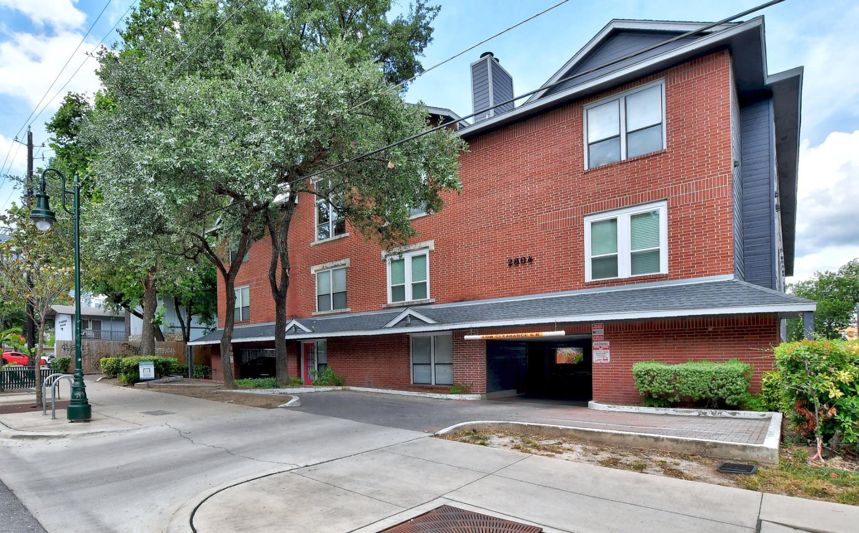 2804 Rio Grande Street, Unit 310 Austin, TX 78705 - Photo 1 of 22 A well-maintained brick building offers a welcoming facade with convenient street-level access.