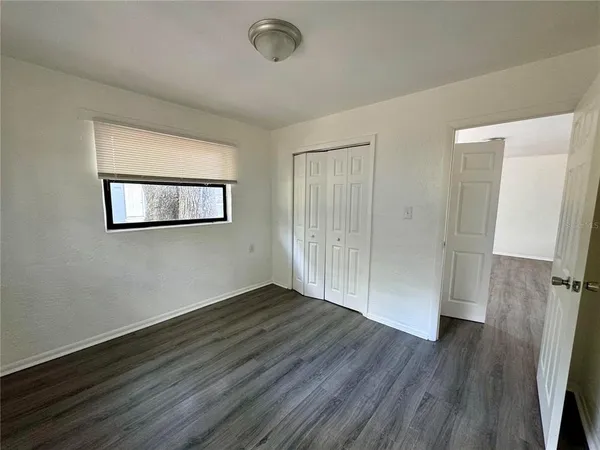 a view of a room with wooden floor and window