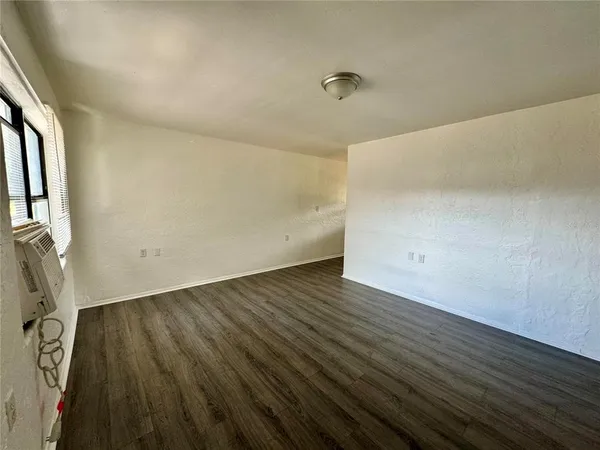 a view of a room with wooden floor