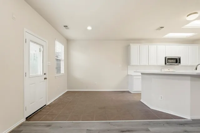 a view of a kitchen with an empty space and a window