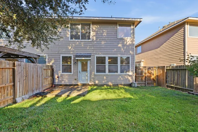 a view of a house with a swimming pool and a yard