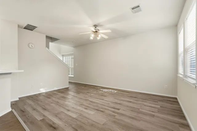 wooden floor in an empty room with a window