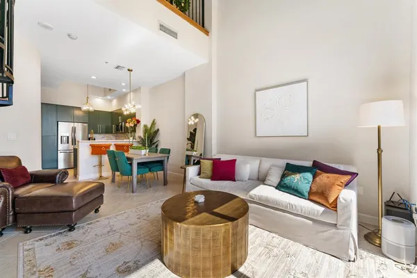 a living room with furniture and a floor to ceiling window