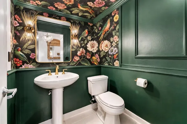 a bathroom with a toilet sink and mirror