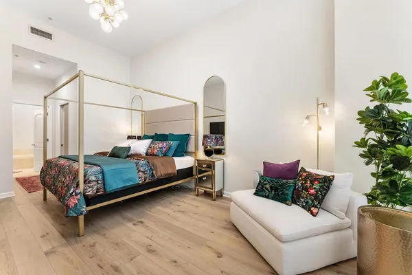 a bedroom with a bed and a window