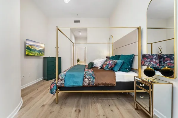 a bedroom with a bed window and a potted plant