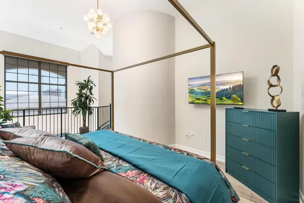 a bedroom with bed and a window