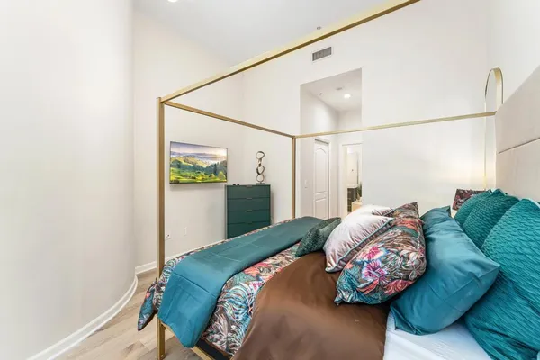 a bedroom with a bed and a window