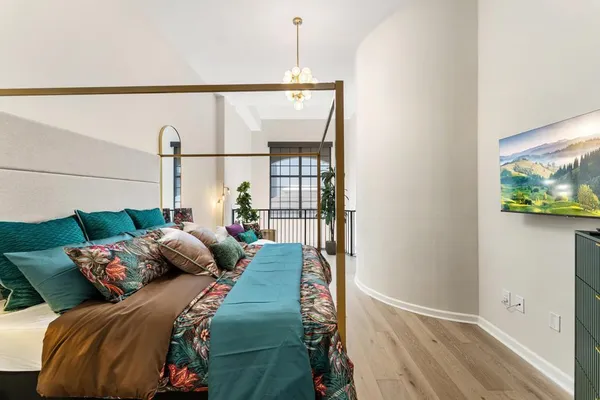 a bed sitting in a bedroom next to a window