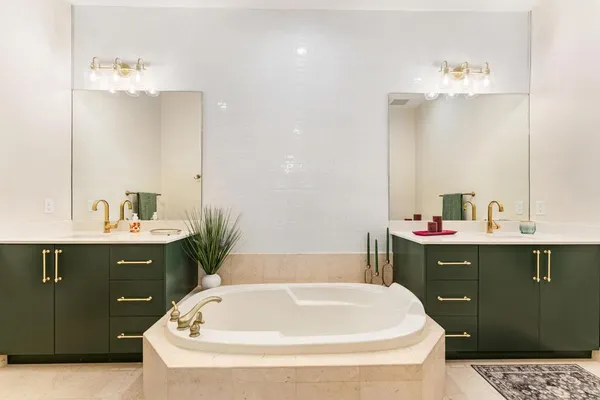 a bathroom with a tub shower and sink
