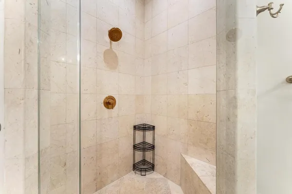 a bathroom with a tub sink and mirror