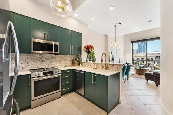 a kitchen with a sink and stainless steel appliances