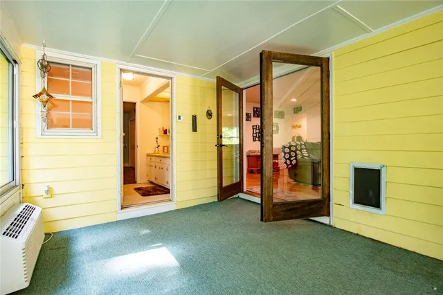 a view of a livingroom with wooden floor and a ceiling fan