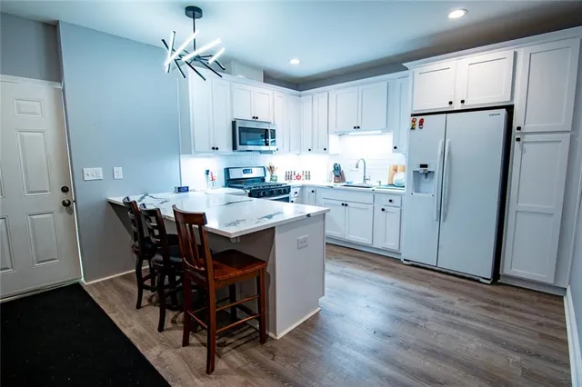 a kitchen with a stove and a refrigerator