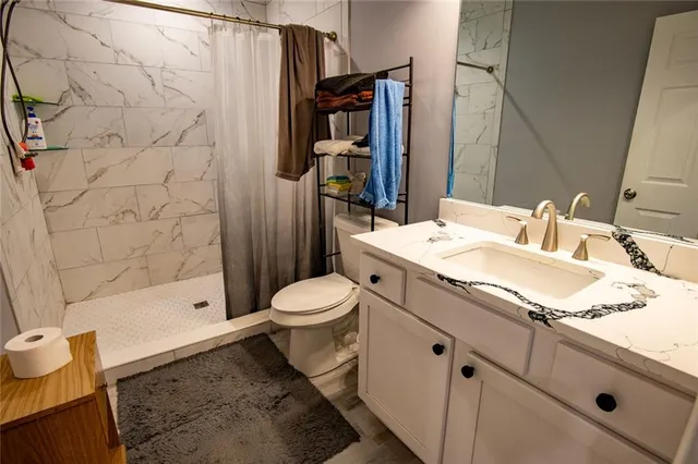 a kitchen with granite countertop white cabinets and white appliances