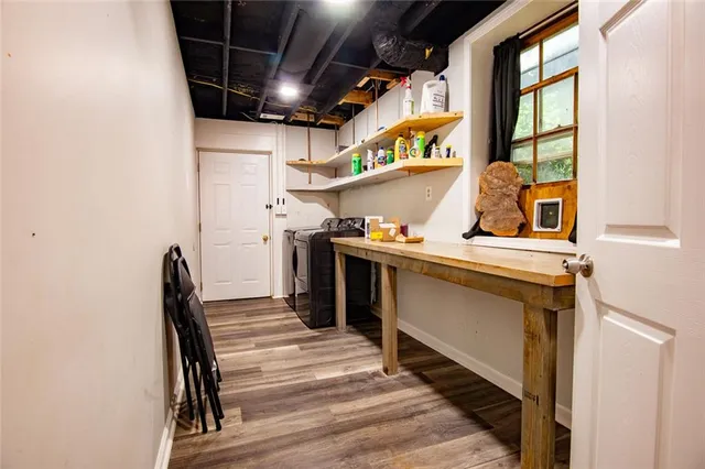 a view of a house with a yard and large tree