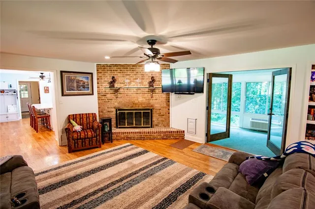 a living room with furniture a fireplace and a chandelier