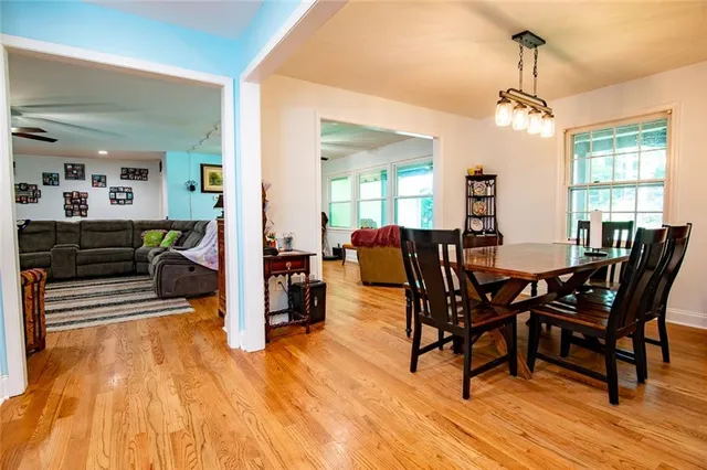 a view of a dining room with furniture and chandelier