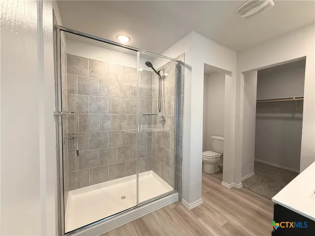 a bathroom with a shower and a toilet