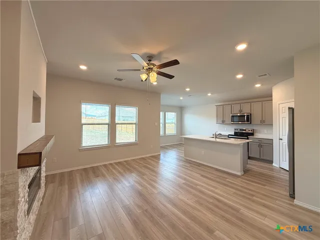a view of kitchen with sink and wooden floor